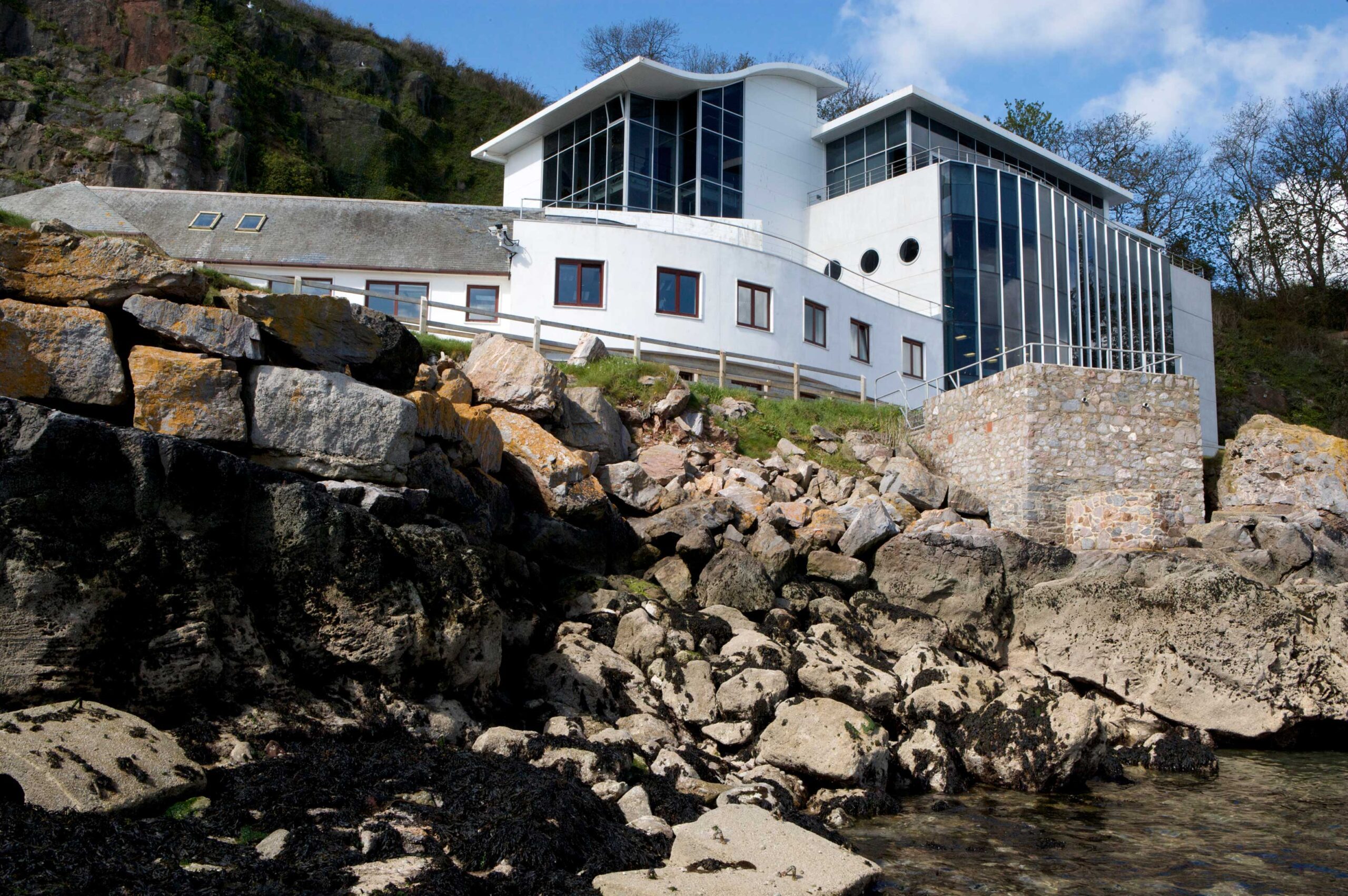 facility on waters edge with rocks below